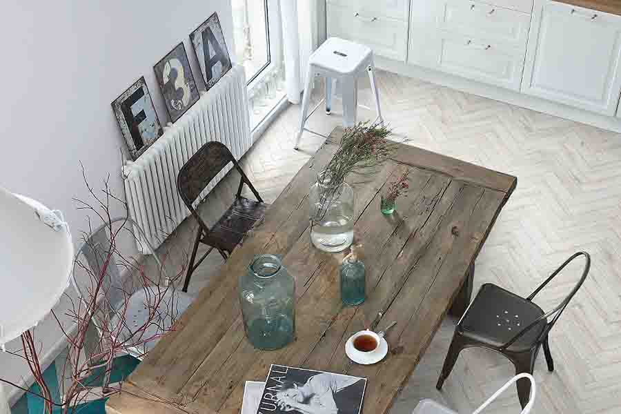 White washed herringbone pattern wood effect porcelain floor tiles in a kitchen